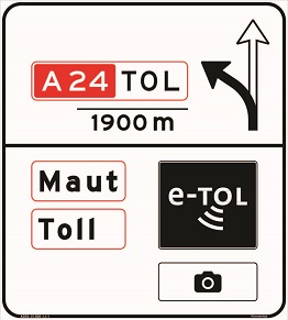 On this sign are the texts 'A24 TOL,' 'Maut,' and 'Toll,' two arrows pointing left and upwards, the e-TOL logo, and an image of a camera.